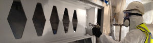 Dry blasting and coating steel beams