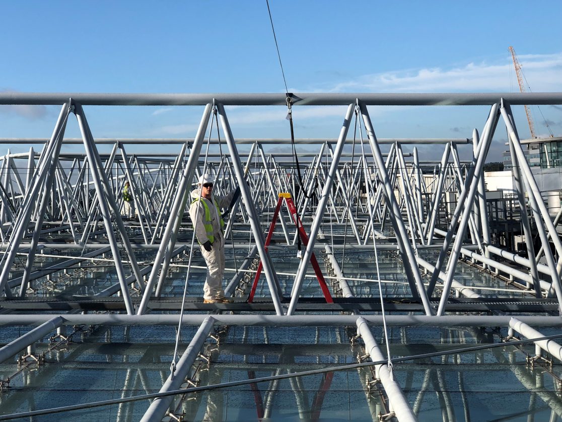 Man working at height with harness.