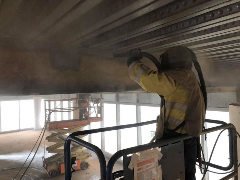 Worker carrying out blast cleaning